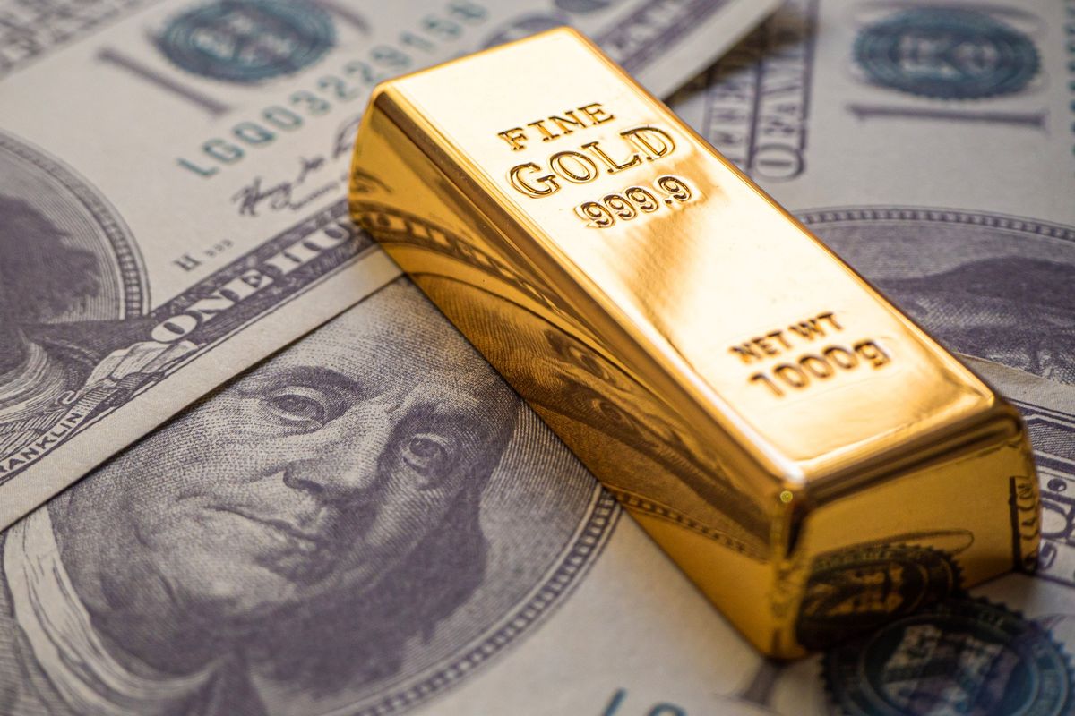 Gold bars on top of US bills.