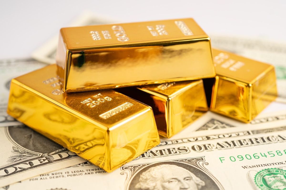 Gold bars on US money.