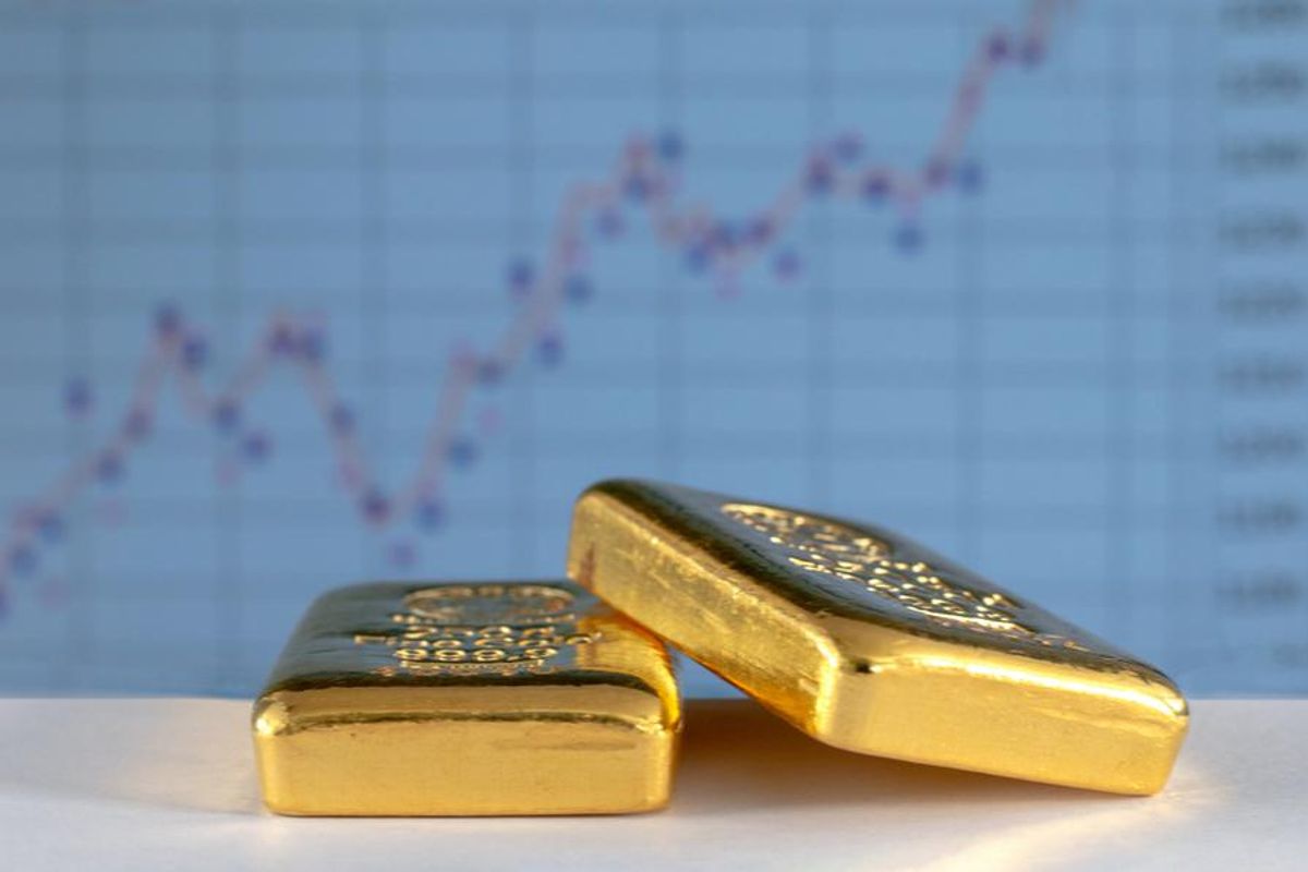 gold bars with stock chart