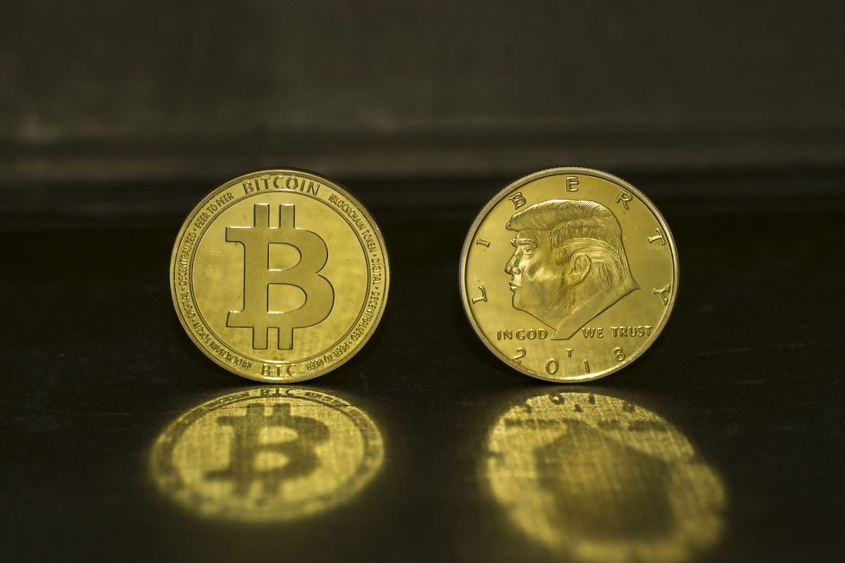 Gold Bitcoins, one with engraved Trump profile.