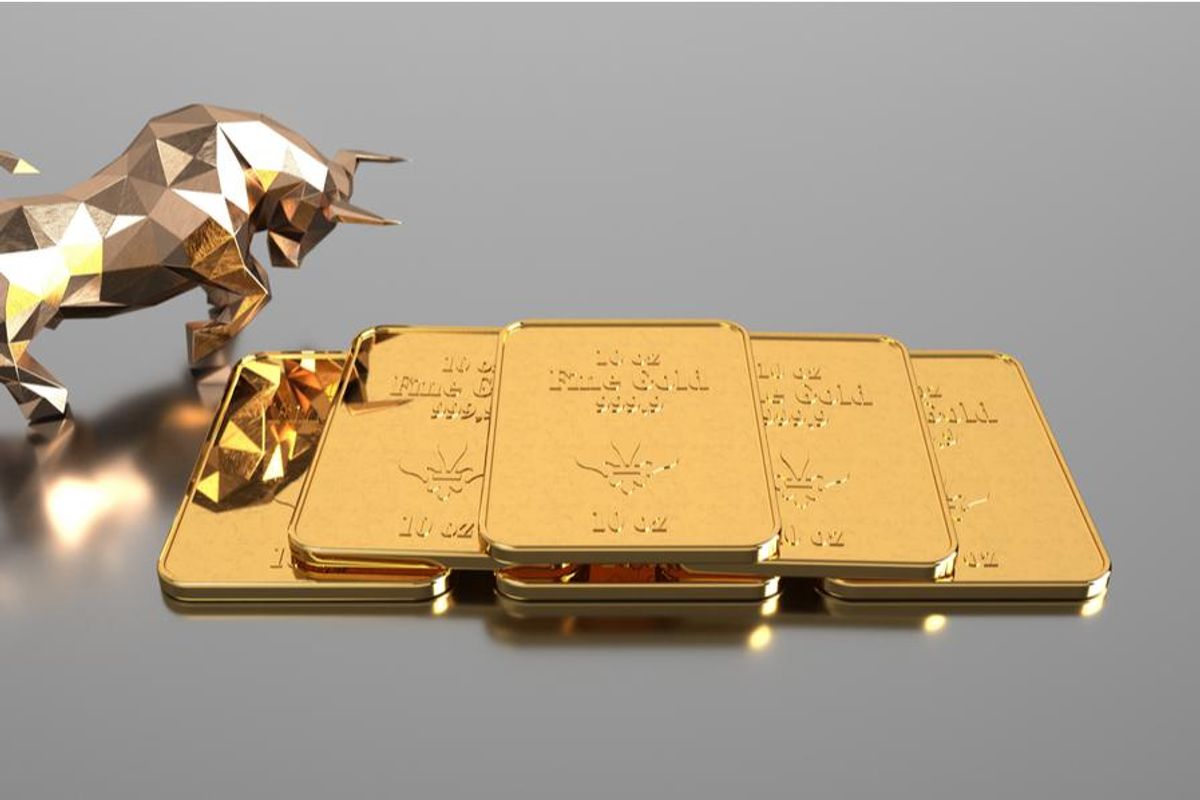 gold bull beside gold bars