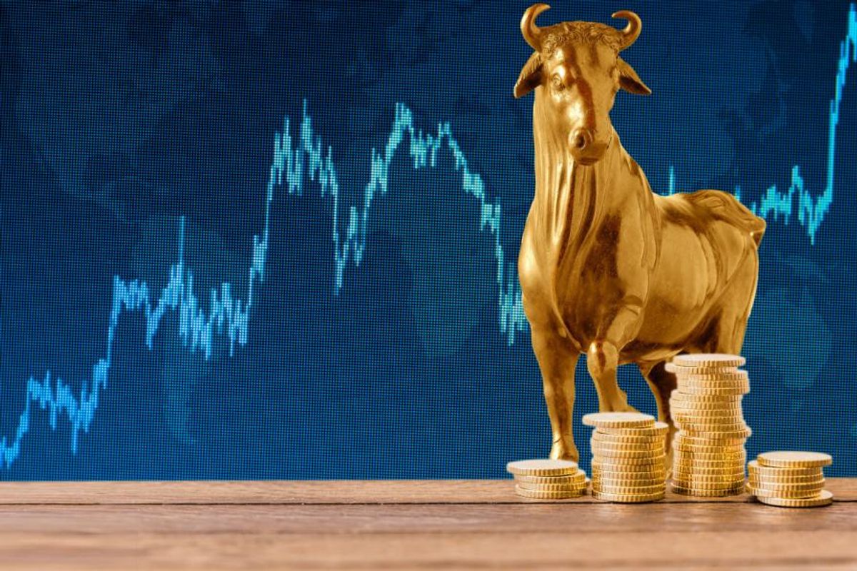 gold bull with blue stock chart