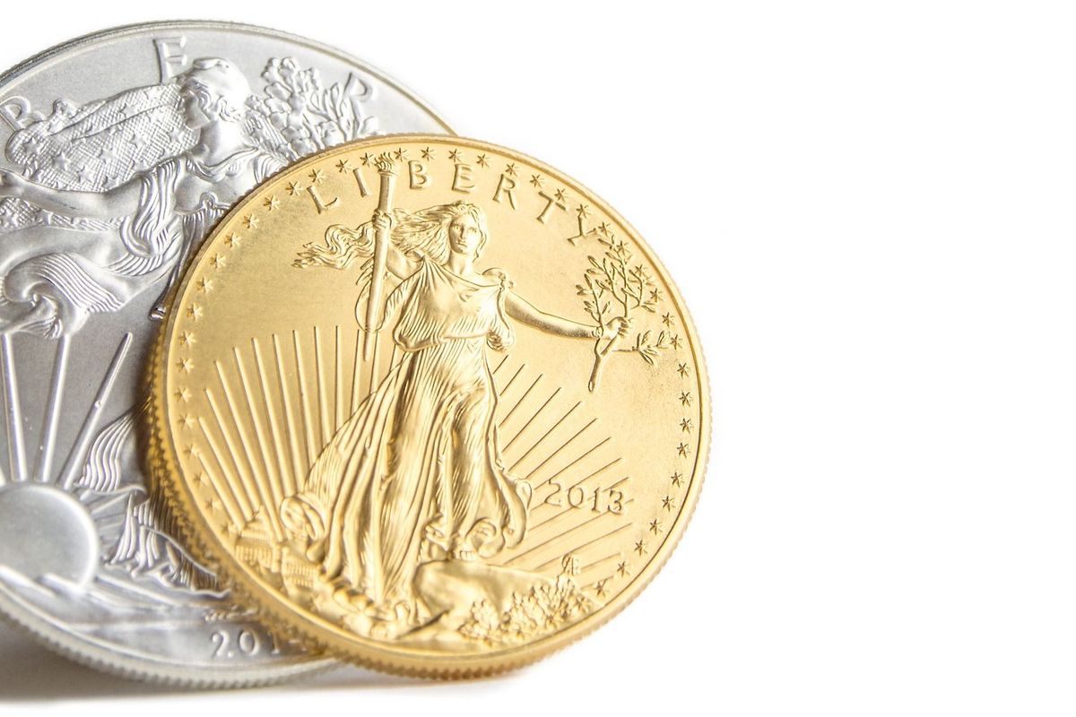 Gold coin with Liberty design overlapping a silver coin.