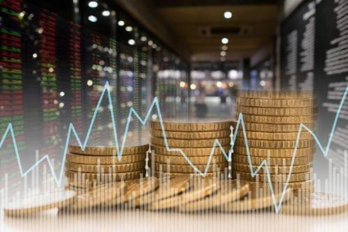 gold coins with stock chart