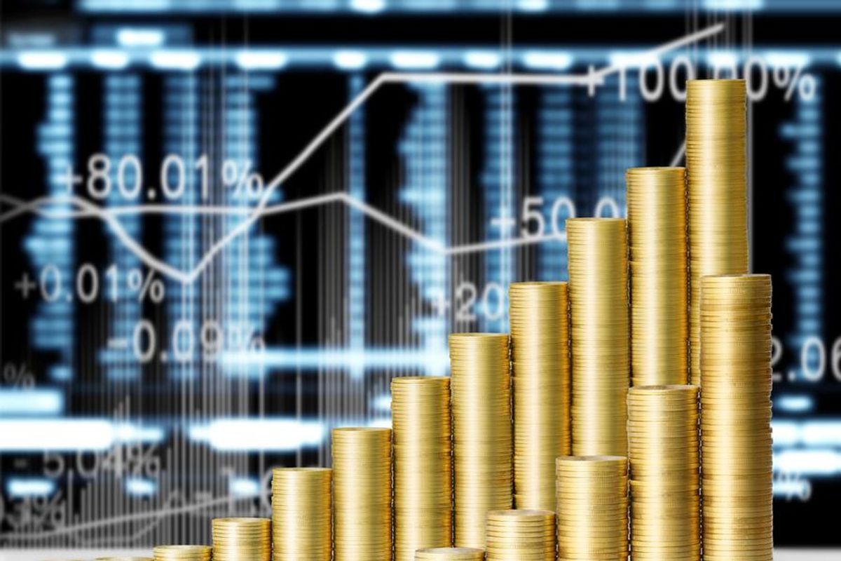 gold coins with stock market graph