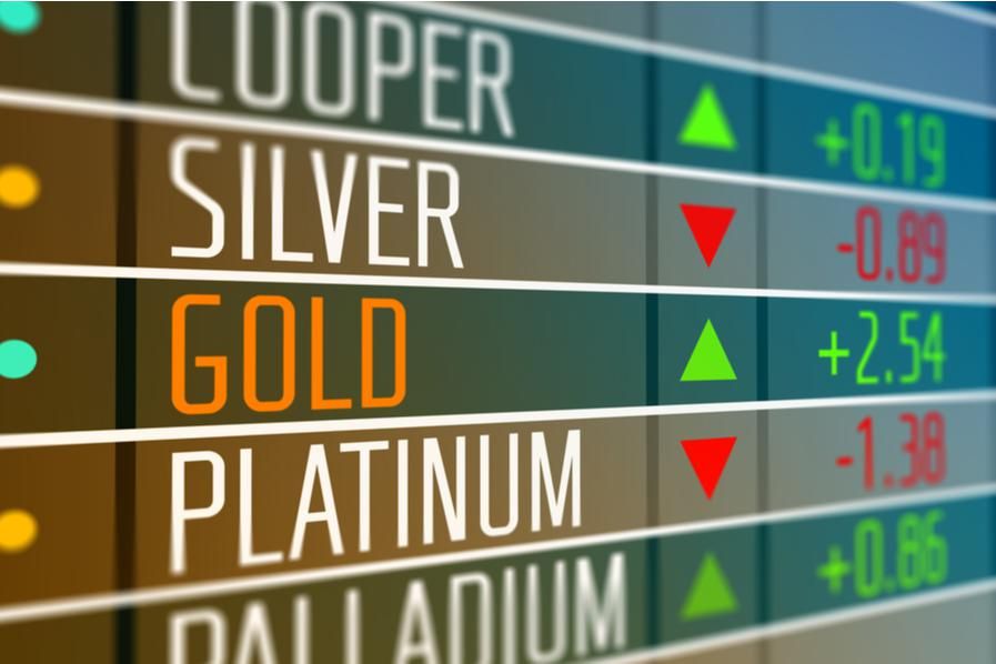 "GOLD" displayed on stock board beside green arrow pointing up
