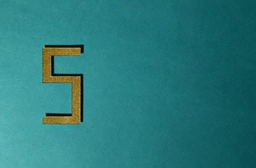 gold five on a teal background