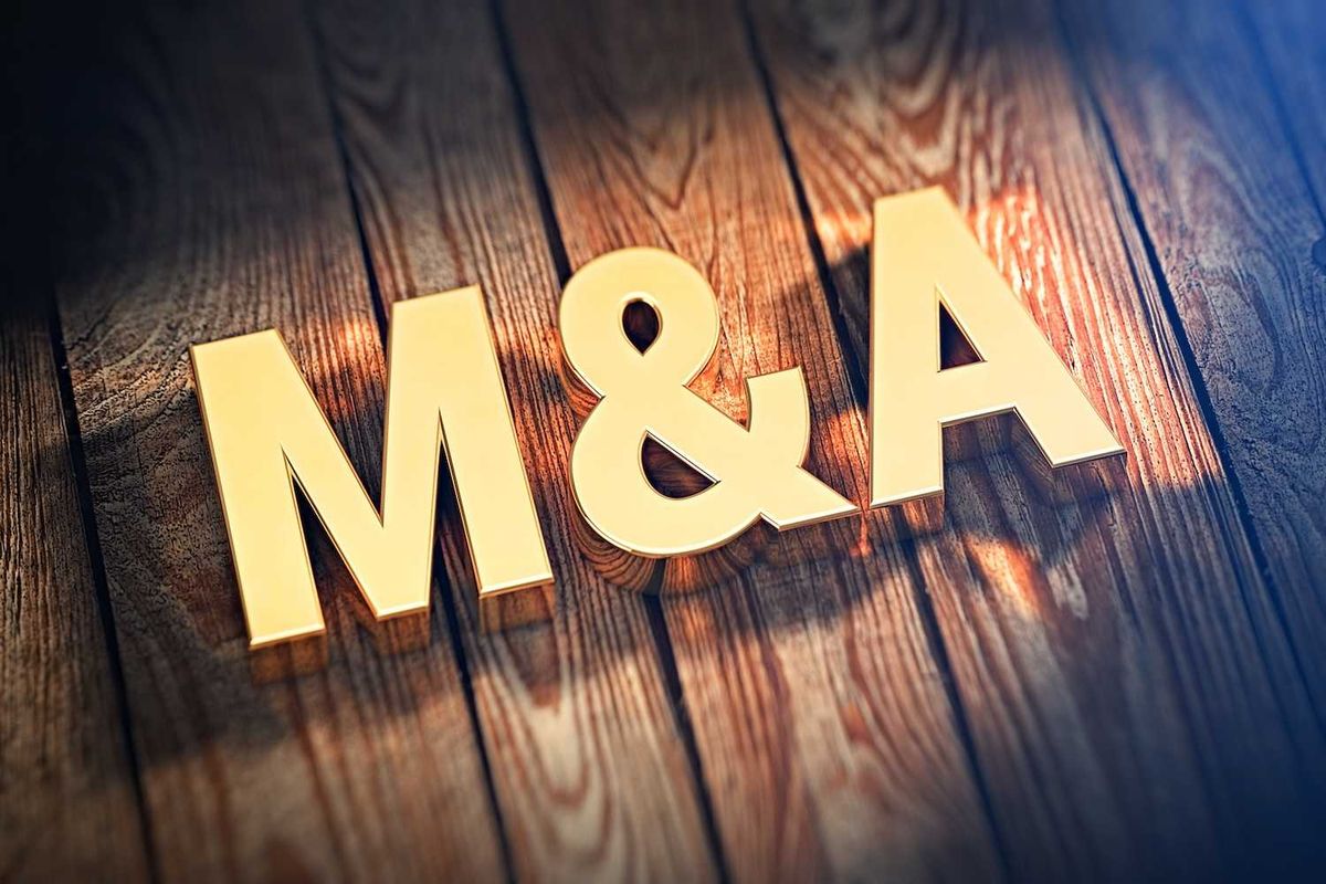Gold "M&A" letters on textured wood background with lighting effects.