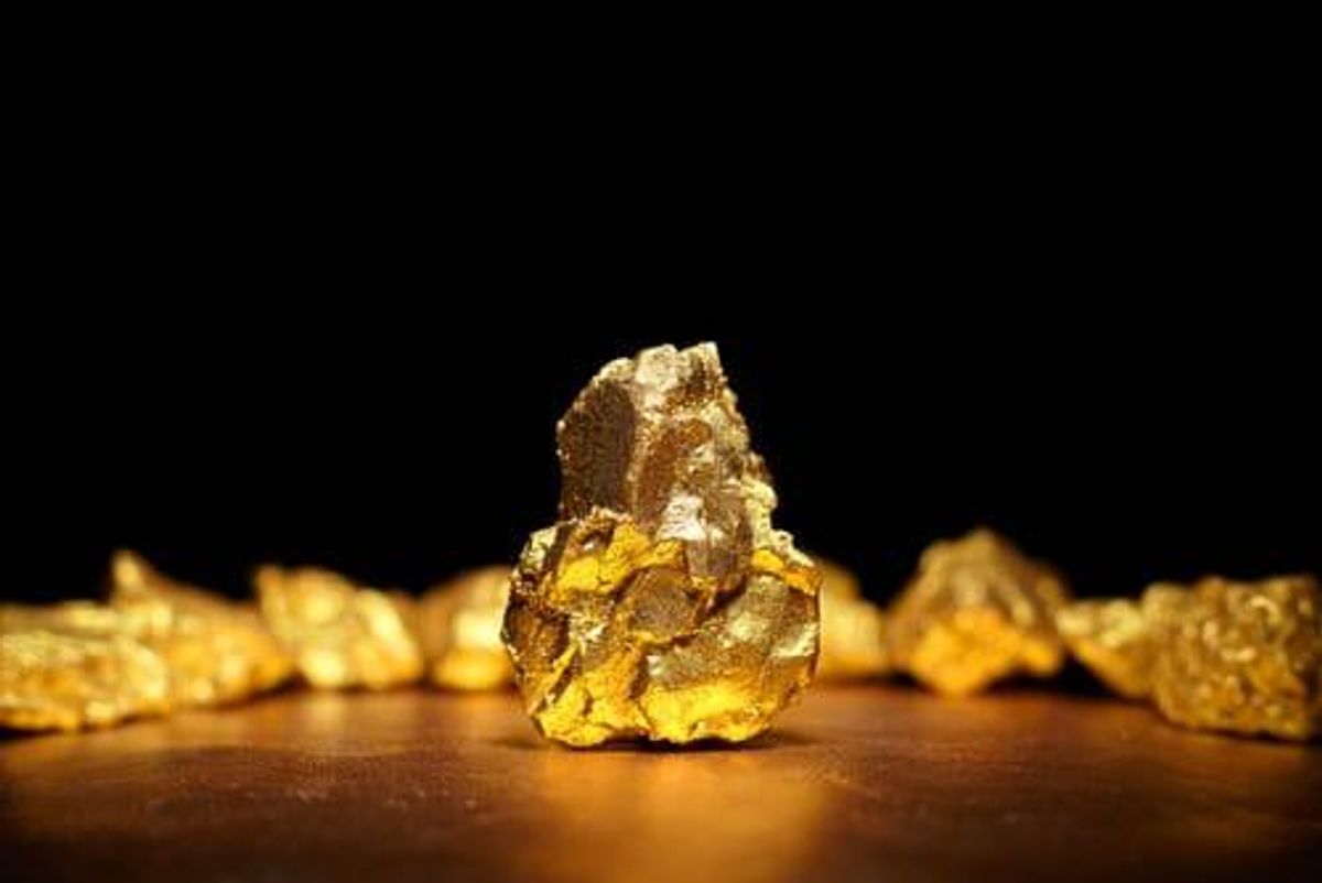 gold nugget surrounded by other gold nuggets