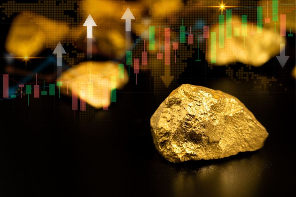 Gold nuggets in front of stock chart.