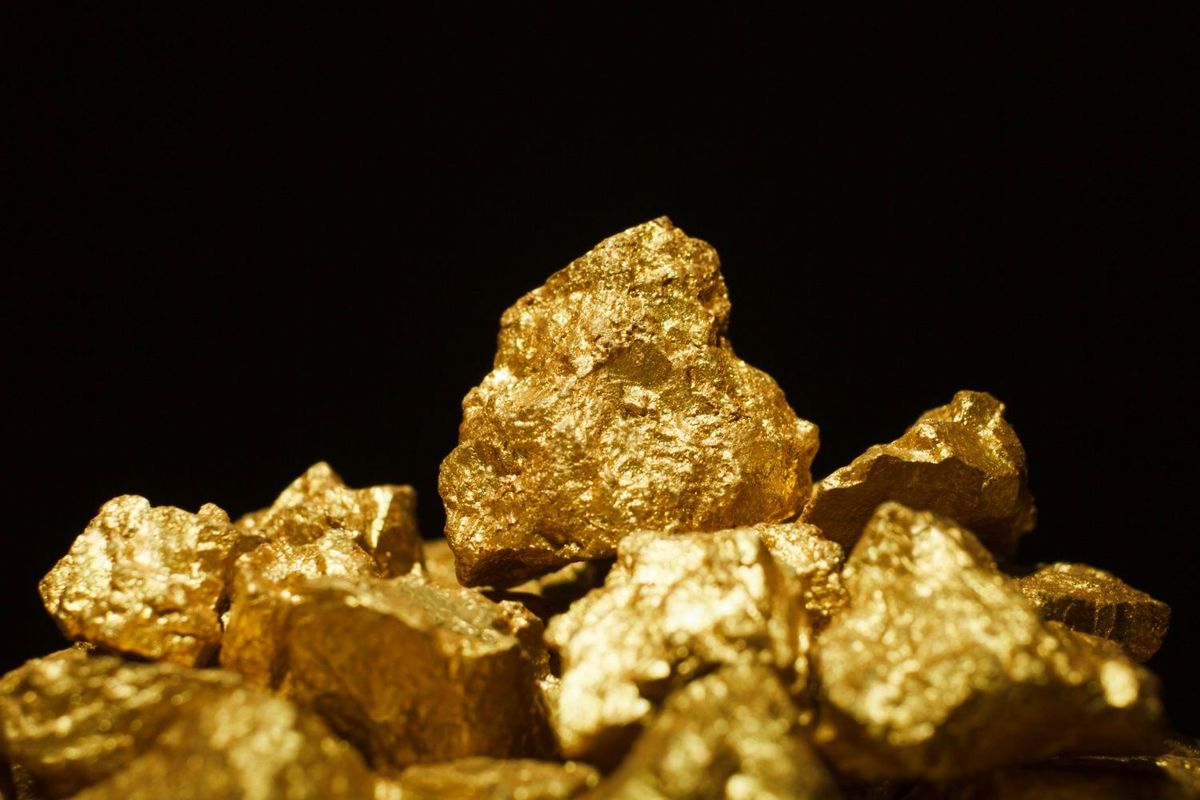 Gold nuggets on black background.