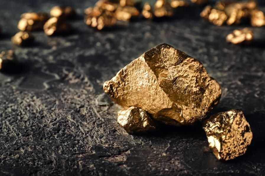 Gold nuggets on dark ground.