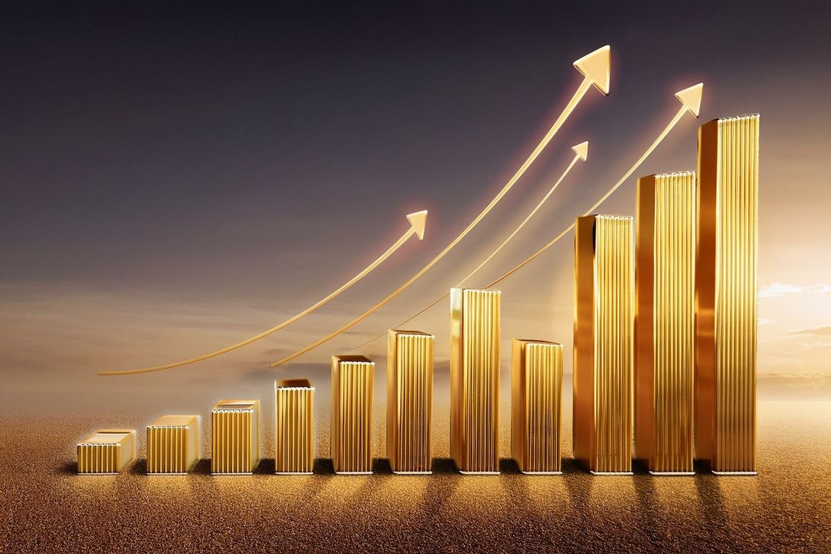 Golden bar graph ascending with arrows, symbolizing growth against a sunset backdrop.