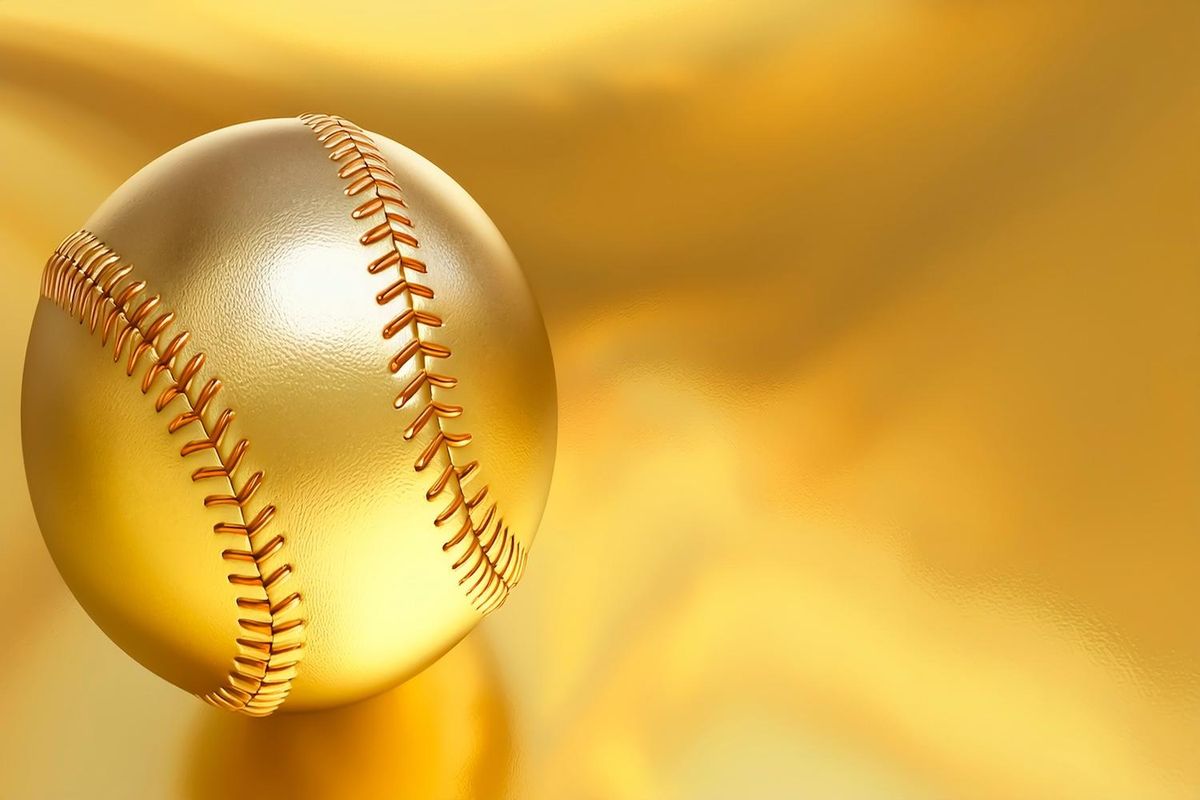 Golden baseball with red stitches on a shiny gold background.