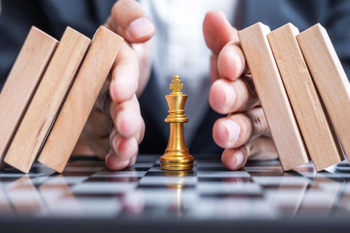 golden chess piece protected from falling blocks