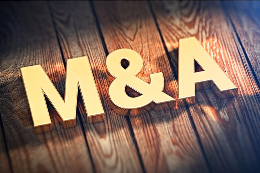 golden "M&A" on wooden background