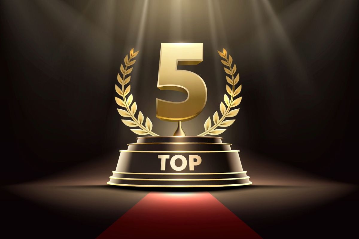 Golden "Top 5" trophy with laurel wreath on stage with spotlights.
