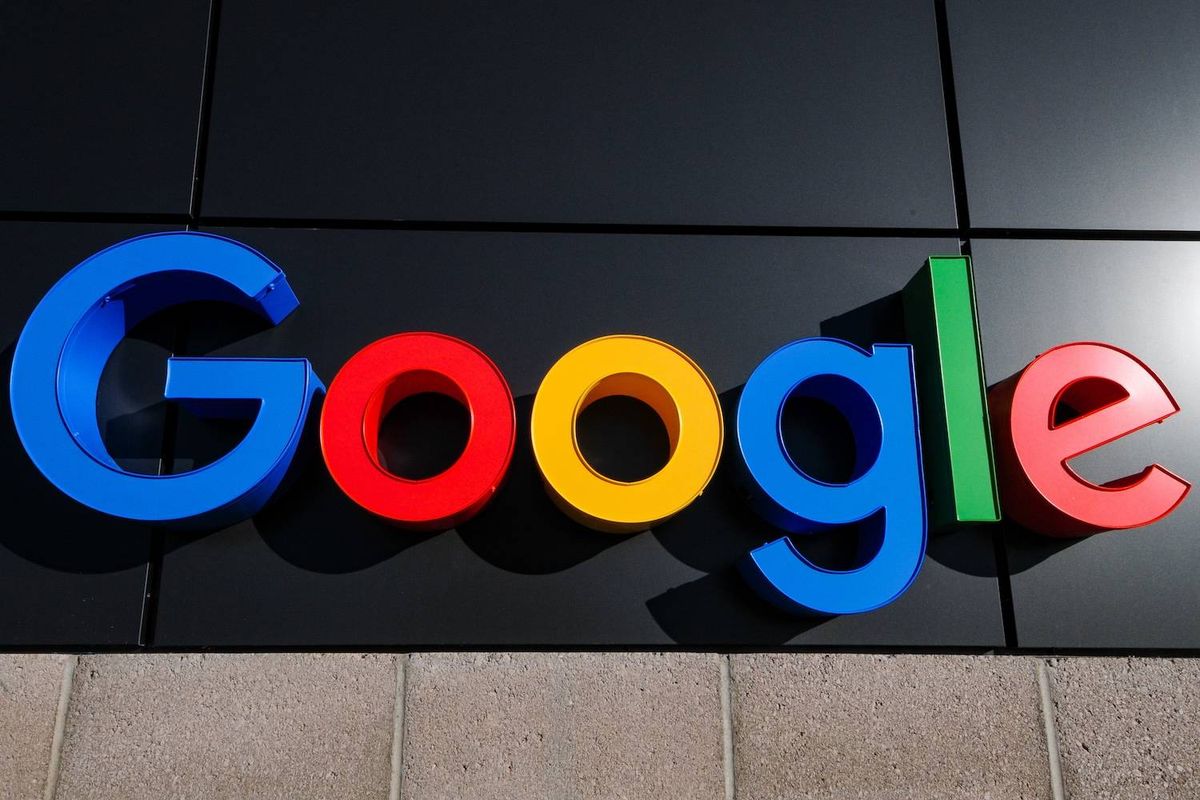 Google logo in bold colors on a dark building facade.
