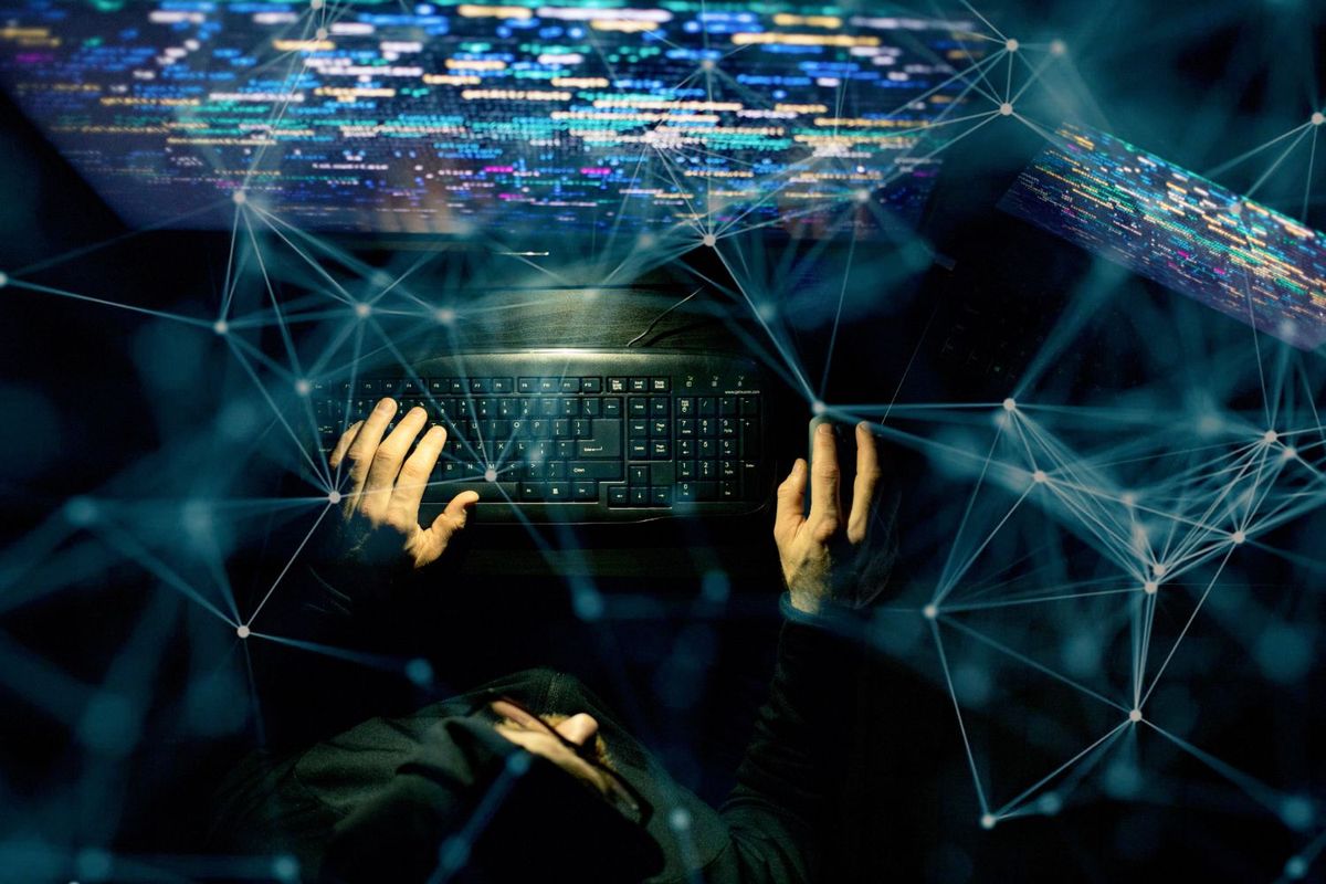 Hacker coding at night.
