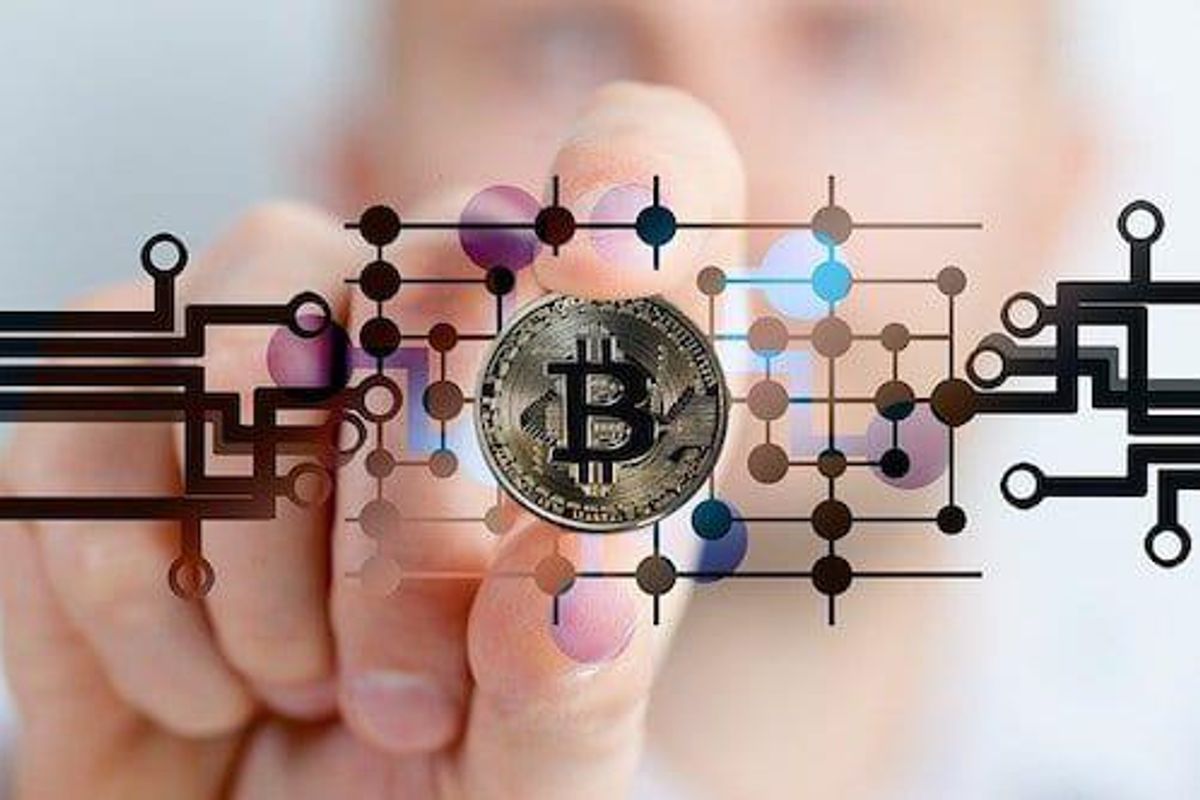 hand holding a representation of a bitcoin