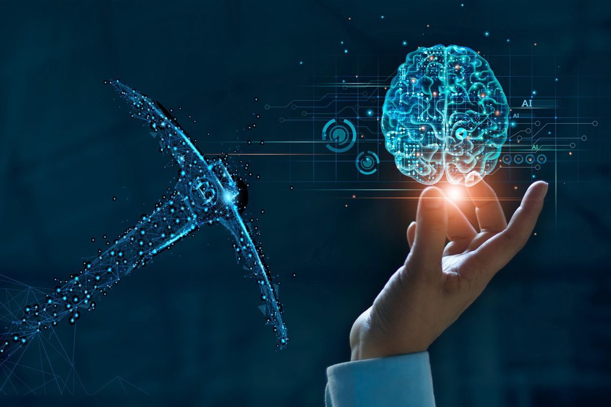 Hand holding an AI brain and a miner's pick.