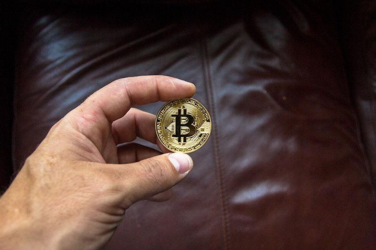 hand holding bitcoin token