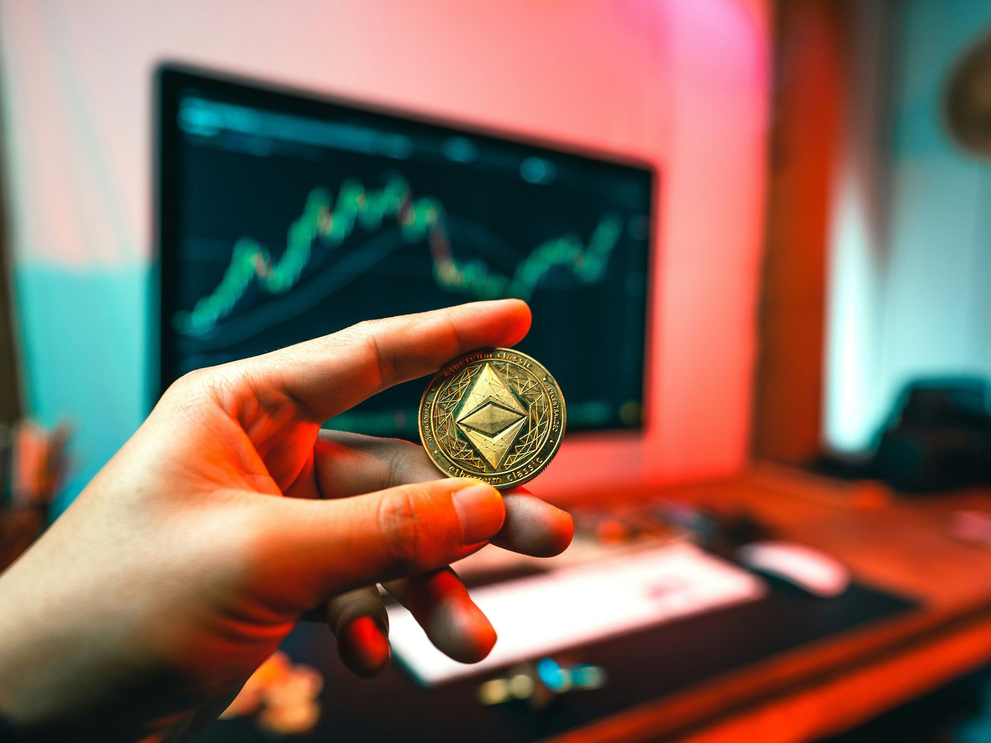 Hand holding Ethereum coin.