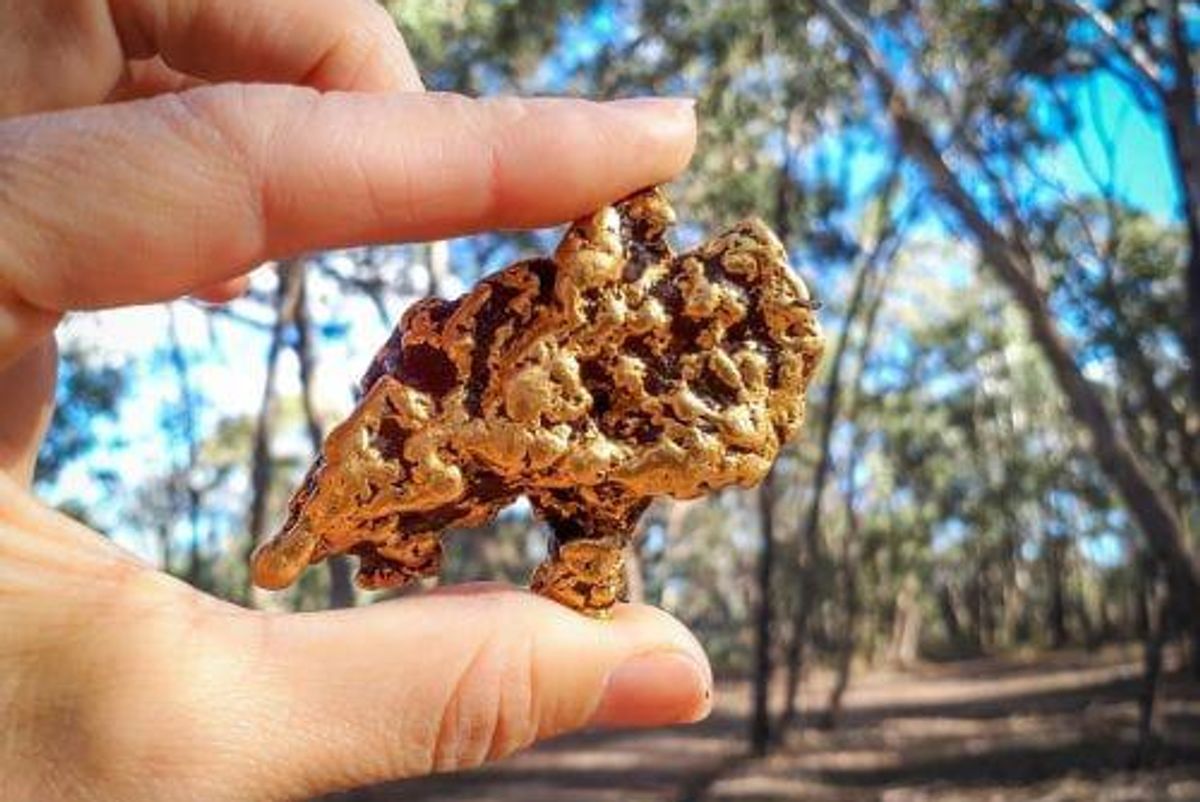 hand holding gold nugget