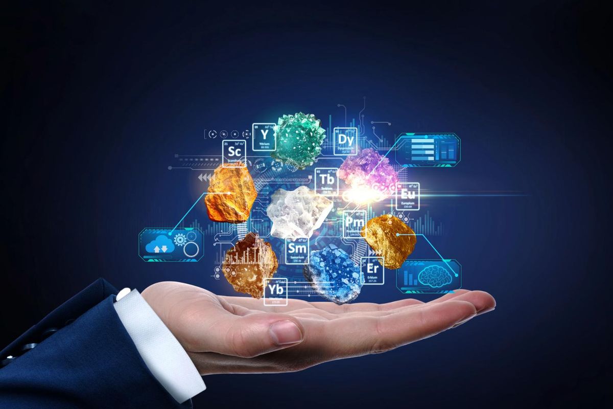 Hand holding holographic rare earths periodic symbol icons.