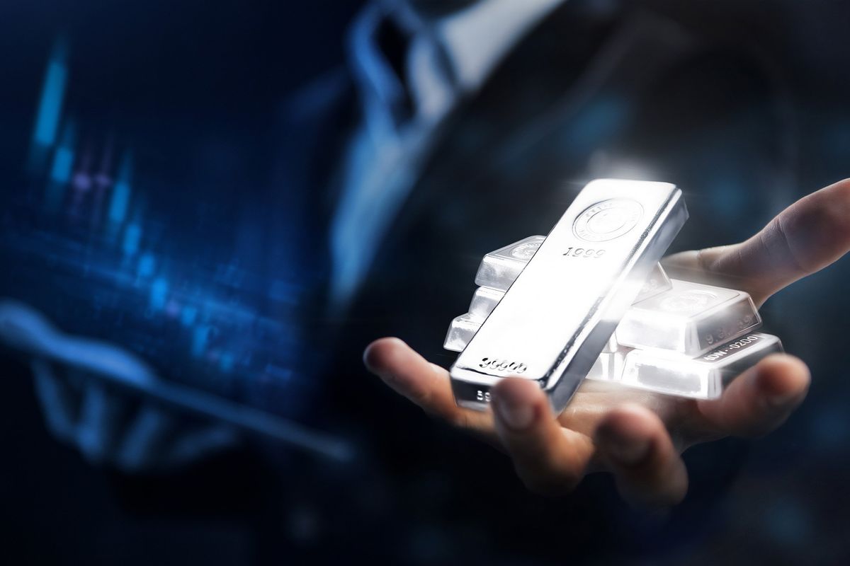 hand holding platinum bars