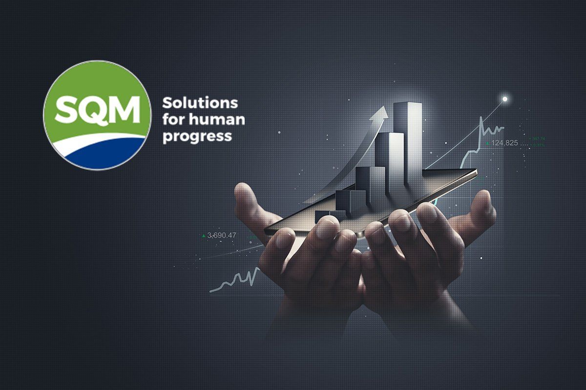 Hand holding stock graph that is increasing. Also SQM logo.