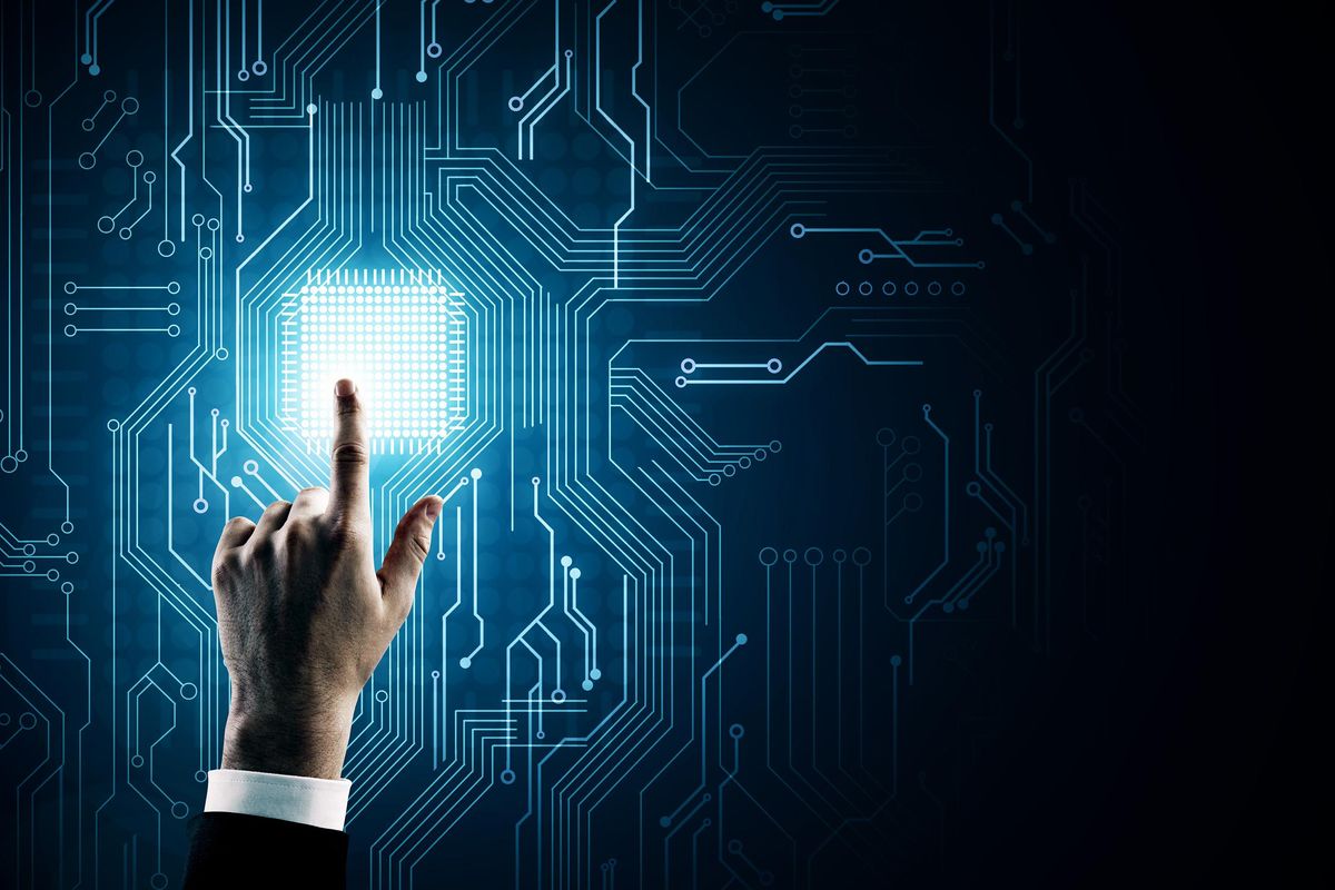 Hand pointing at creative circuit background with chip.