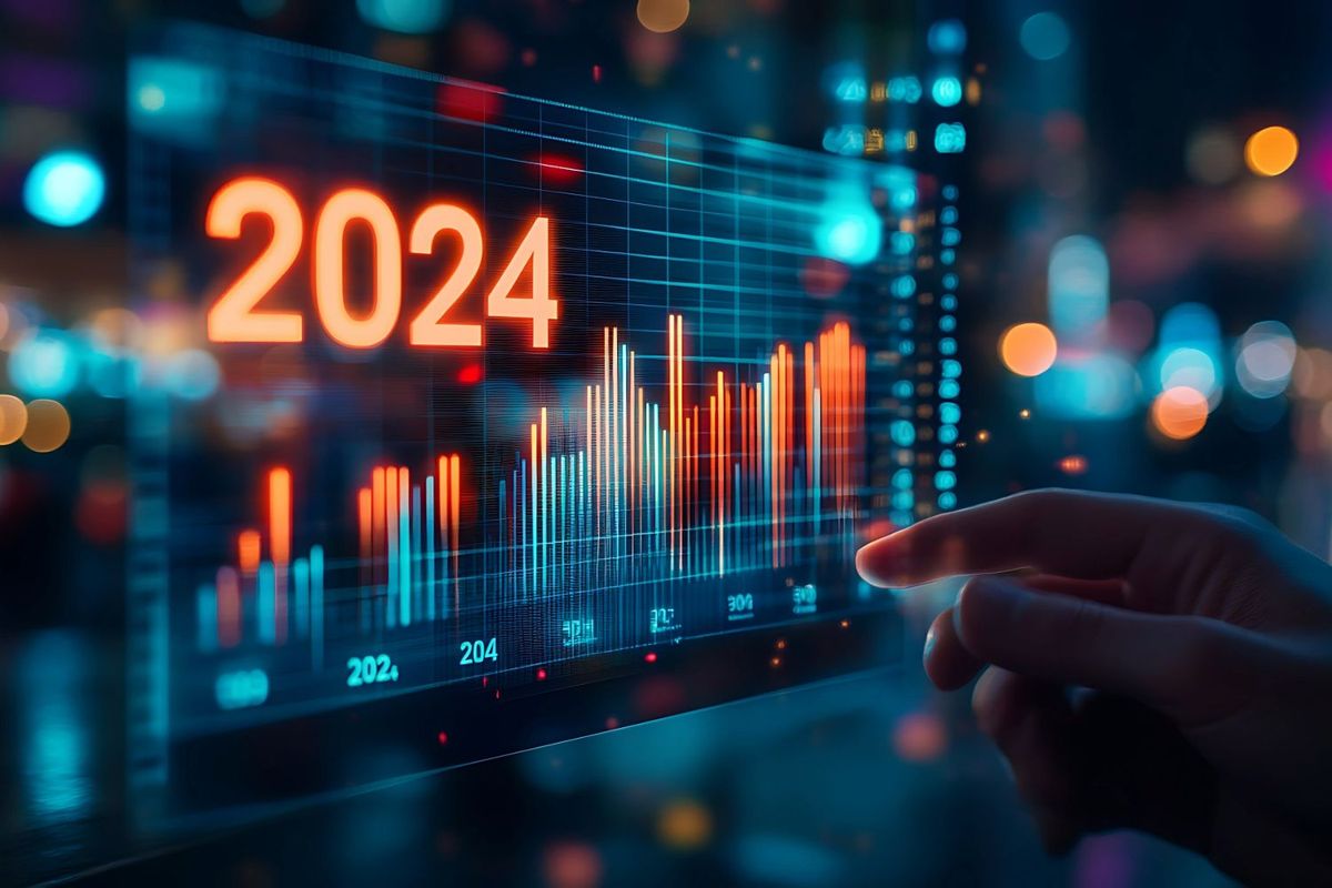 Hand reaching toward stock screen with "2024" on it.