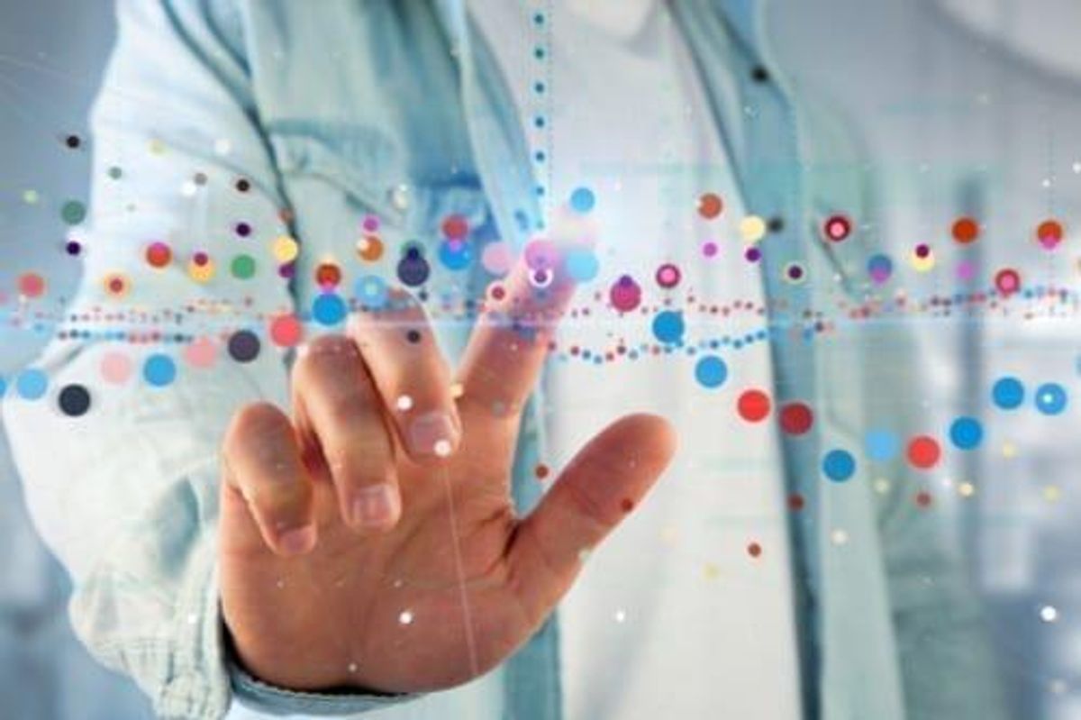 hand touching floating colored bubbles representing stock charts