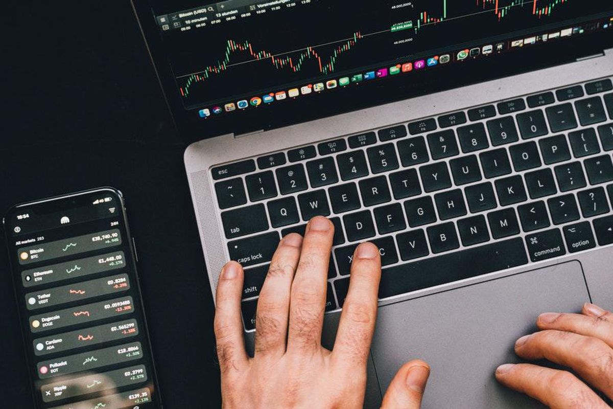 hands on laptop with phone