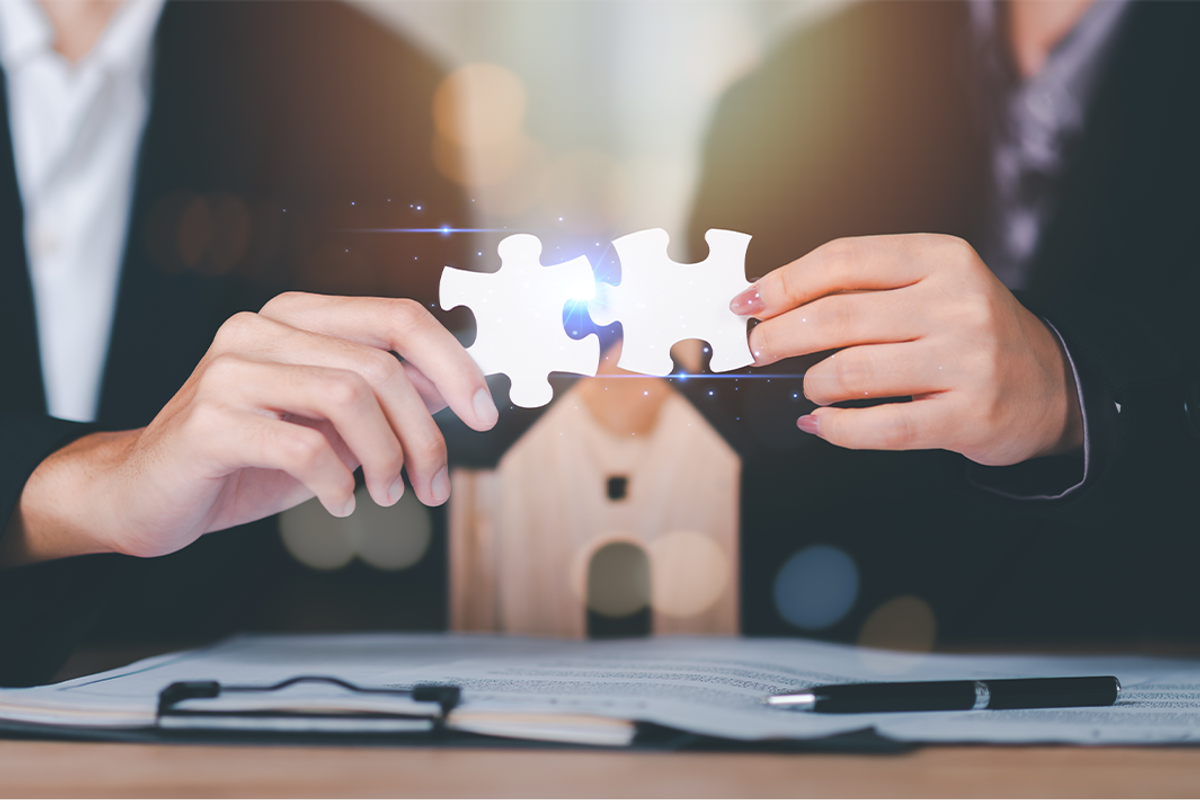 Hands putting puzzle pieces together.