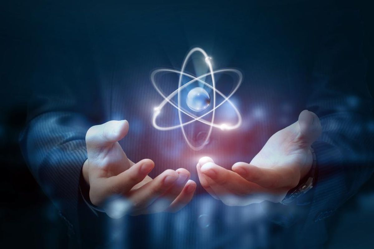 Hands shows the atom on a dark blurred background