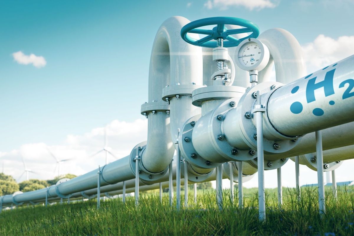 Hydrogen pipes in a green grass field on a sunny day.