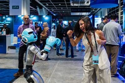 An attendee interacts with a robotics demonstration on the exhibition floor at Consensus Hong Kong 2026.