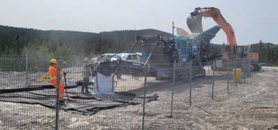Figure 4: Crushing of spodumene pegmatite boulders into bulk bags. (CNW Group/PMET Resources Inc.)