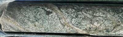 Core photo from DKD049 (541 m downhole) showing vein-hosted and disseminated chalcopyrite and pyrite mineralisation in strongly A-B veined tonalite host rock. Broad 180 m down-hole visual drill intersection represents a significant 175 m step-out to La Verde's high-grade core along its eastern flank, assay results expected May 2026[1] (CNW Group/Hot Chili Limited)