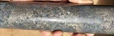Figure 2: Harzburgite with semi-massive sulphide + chromite rich interval (203.66m) in drill hole DDH26LU330. (CNW Group/Bravo Mining Corp.)