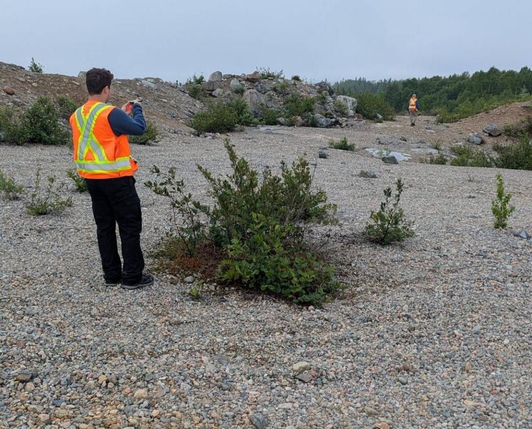 Figure 3- AIS team locating drill holes
