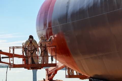 Applicators electrostatically apply PPG SIGMAGLIDE® 2390 marine coating to a vessel hull. The biocide-free fouling release technology helps improve vessel efficiency and reduce emissions.
