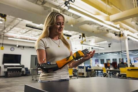 Annika using her customized prosthetic limb with color-shifting paint from Limbitless Solutions, developed using Stratasys-enabled manufacturing processes.