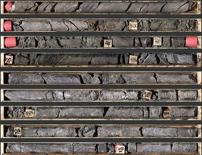 Photo 1: An interval of pink facies and massive sulphide mineralization in TS26-003 consisting of laminated to massive sphalerite, galena, and barite from 1,021.4 to 1,031.4 m