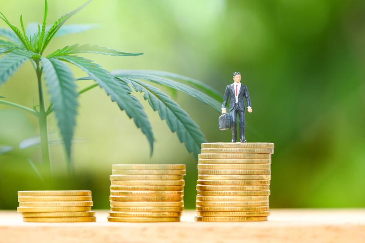 investor figurine atop pile of coins