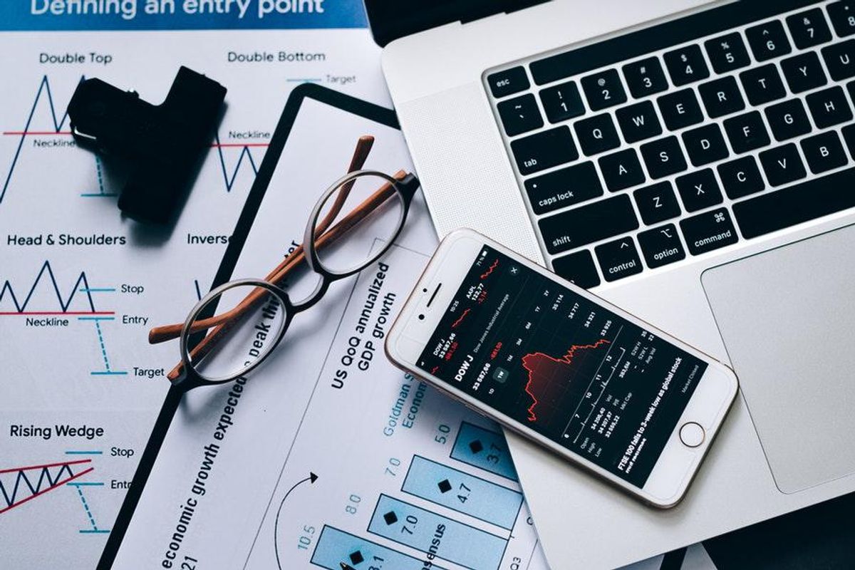 iphone with laptop and stock charts