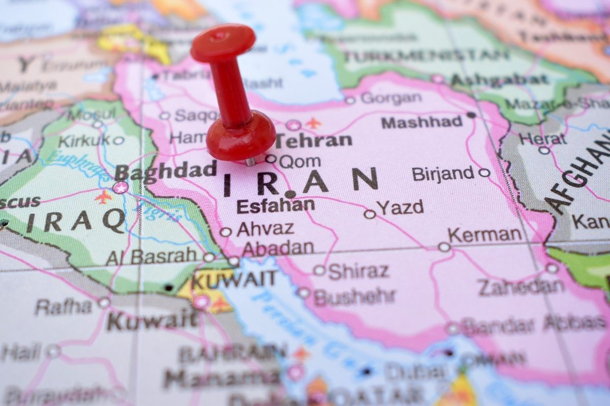 Iran on a map with a red push pin.