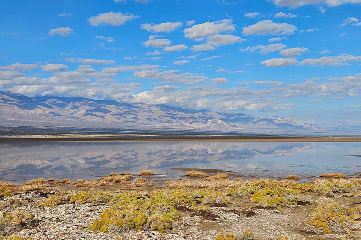Landscape with sky, mountains and water.